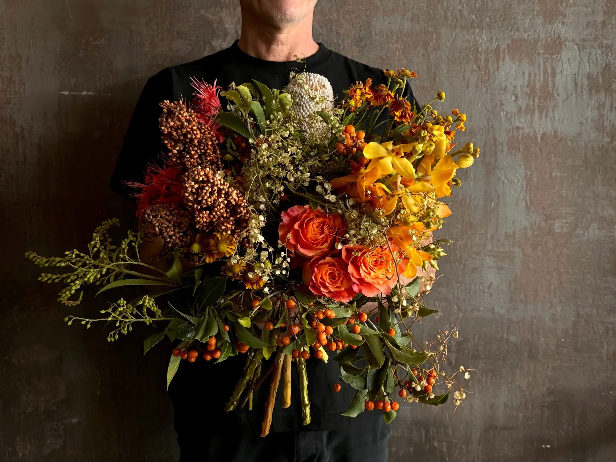 Florist holding a hand-tied bouquet ready for flower delivery to Surry Hills