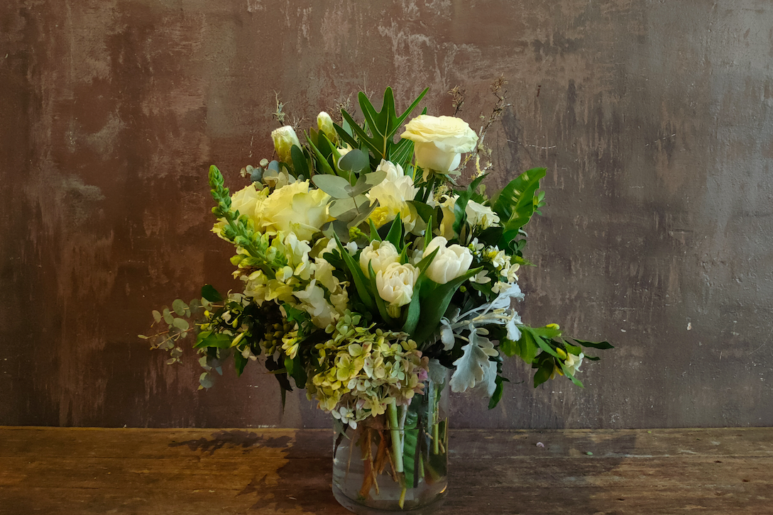 White and green flower arrangement in a glass vase - bouquet vs flower arrangement
